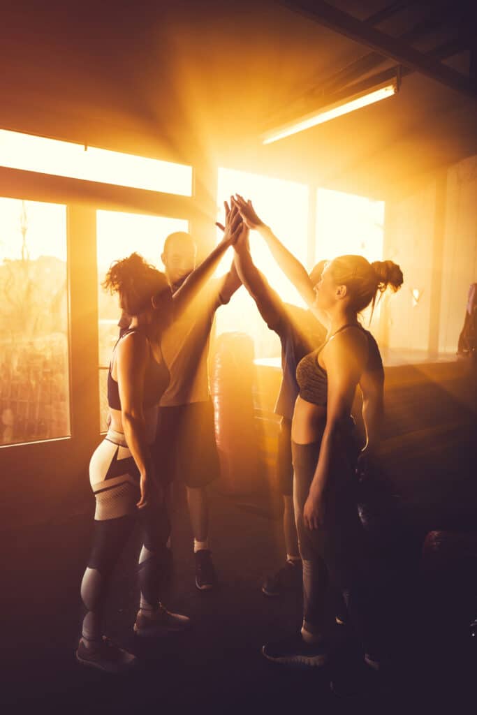 Athletes high fives after successful workout